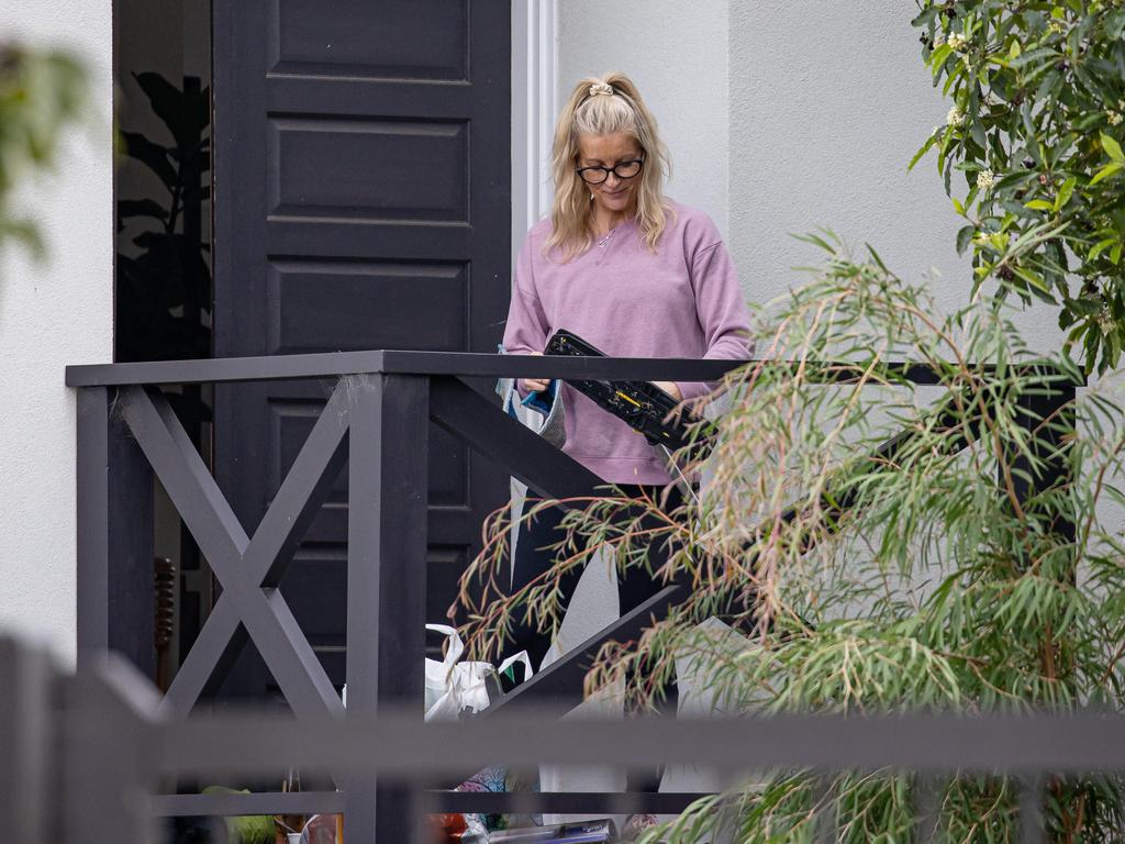 Cleaners attend the Airbnb where Jamie Kah was found.