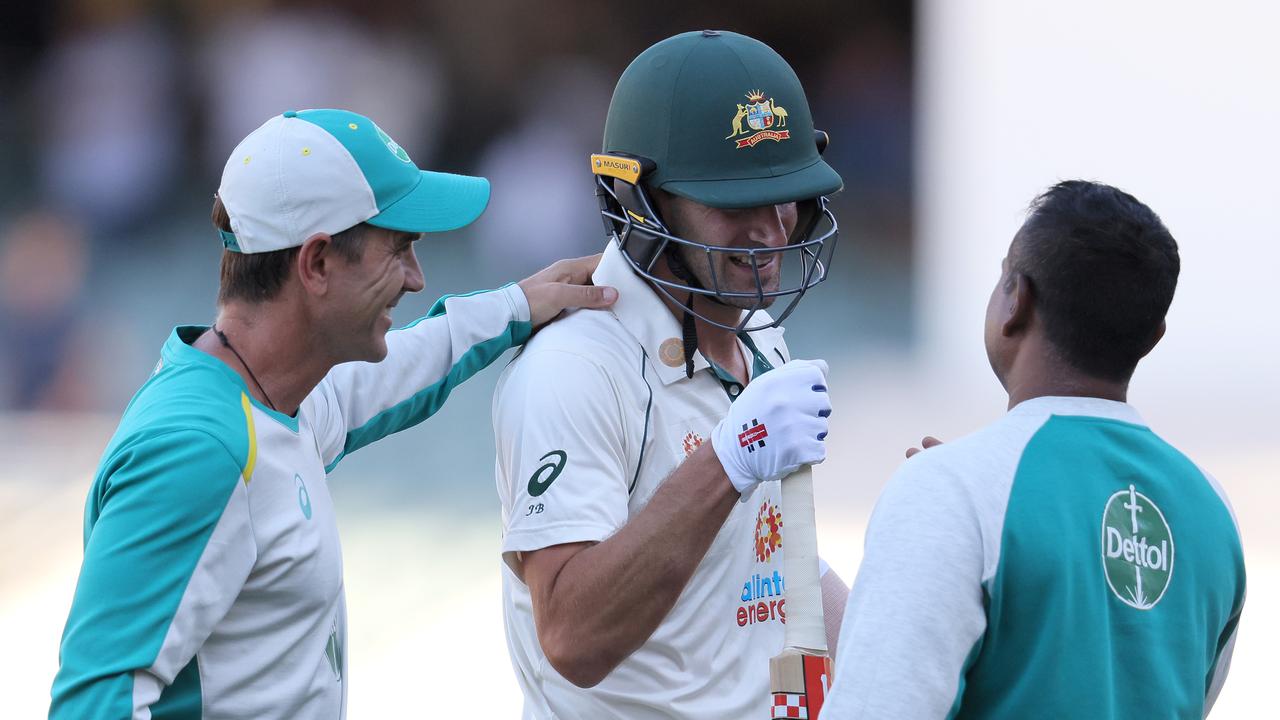 Joe Burns is congratulated by coach Justin Langer. Picture: Getty