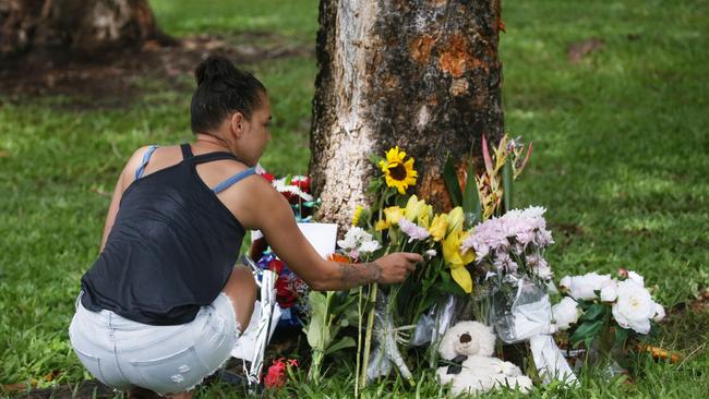 Bradley Smith was declared dead at the Pease St crash site and five other children aged 12 to 15 were taken to Cairns Hospital with injuries. Denise Weazael of Manoora lays some flowers at the scene of the crash. Picture: Brendan Radke