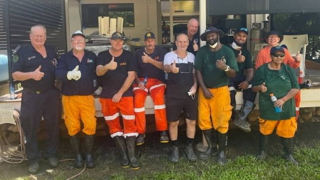 Ted Fay (white shirt) and fellow SES and RFS volunteers cleaning up his home in Cardwell. Picture: Supplied