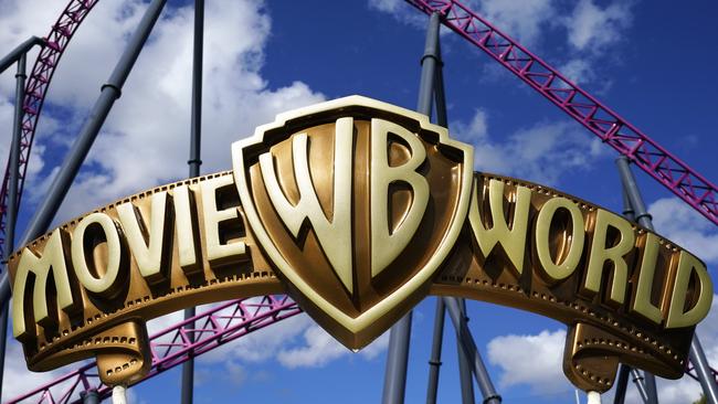 Warner Brothers Movie World sign is seen in front of a rollercoaster track at Movie World on the Gold Coast.