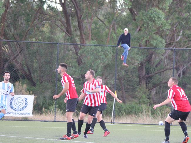 The man scales the fence…