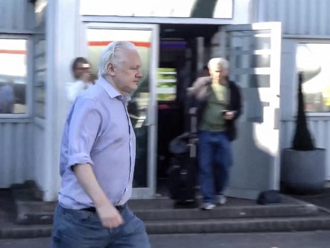 Julian Assange walking to board a plane from London Stansted Airport. Picture: AFP