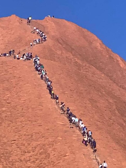 A huge line of tourists climbing up Uluru ahead of the upcoming closure. Picture: Glenn Minett