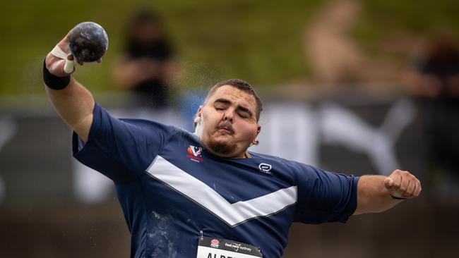 No pain no gain. Competitors in the men's U20 shot-put grimacing with effort as they compete.