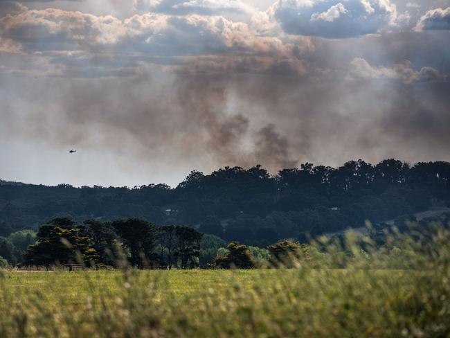 Thick smoke in the sky as tankers and aircraft battle the blaze. Picture: Ian Wilson