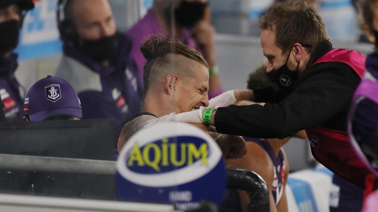 Nat Fyfe has his shoulder assessed. Picture: Will Russell/AFL Photos via Getty Images