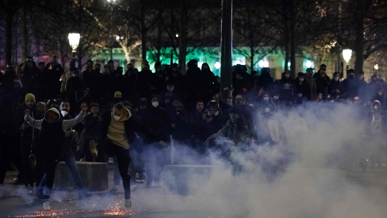 Protesters, surrounded by tear gas, face riot mobile gendarmes during a demonstration. Picture: Ludovic Marin/AFP