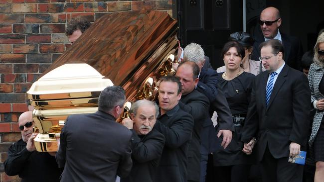 The gold coffin carrying Williams’ body is carried out of St Therese’s Church in Essendon.