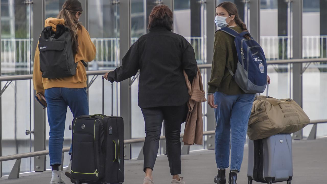 Passengers arrive at Adelaide airport wearing masks. Picture: NCA NewsWire / Roy VanDerVegt