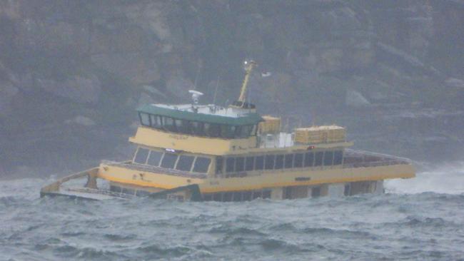 One of the three new, smaller and faster Manly ferries, the “Fairlight” battles through the large swell coming through Sydney head on Friday morning. Picture John Grainger