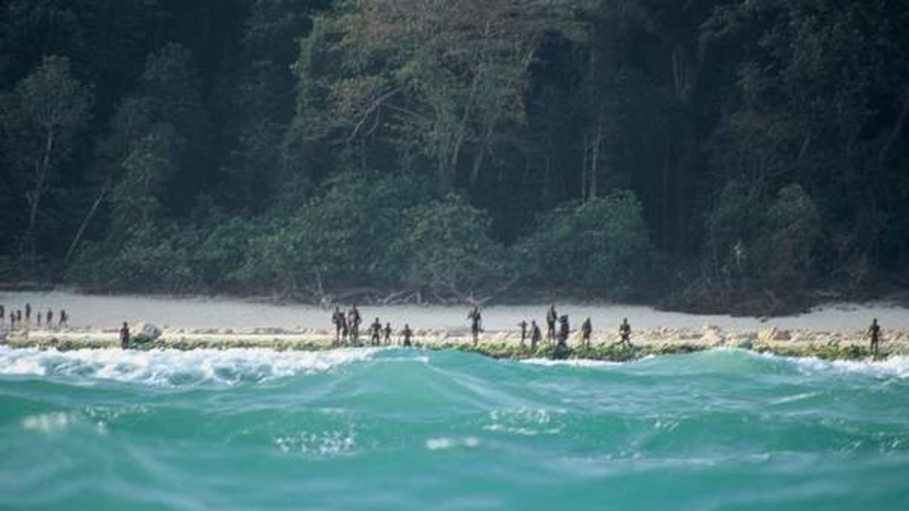 The Sentinelese stand guard on an island beach. Most contact with the tribe has been made from boats sitting just outside arrow range. Picture: Christian Caron – Creative Commons A-NC-SA