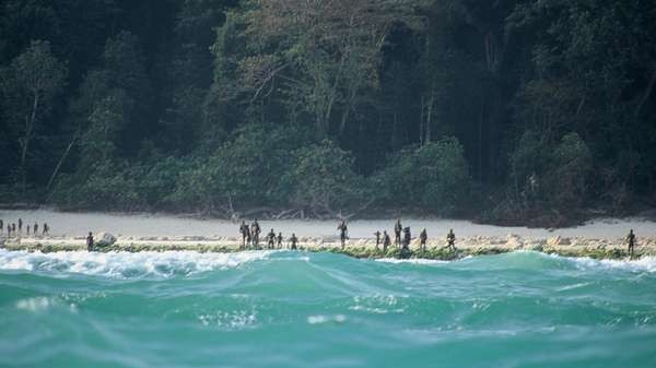 The Sentinelese stand guard on an island beach. Picture: Christian Caron — Creative Commons A-NC-SA