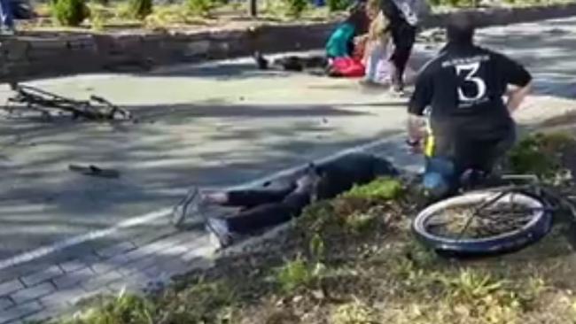 A person lies face down on the bike path. Picture: Twitter