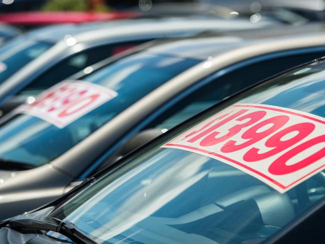 Generic image of vehicle with splash price tag in used car yard.