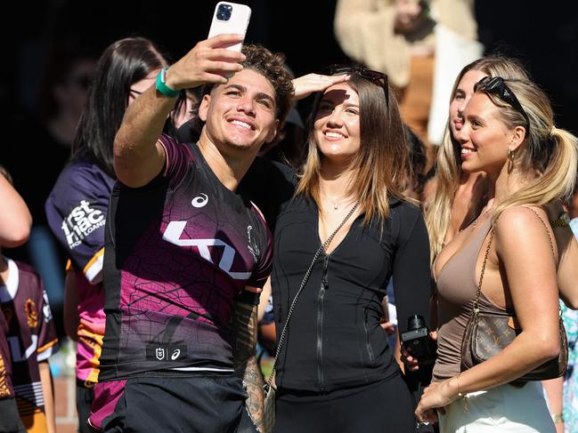 Reece Walsh with Charlize Knudsen (right) and the Brisbane Broncos train at Red Hill in Brisbane. Pics Adam Head