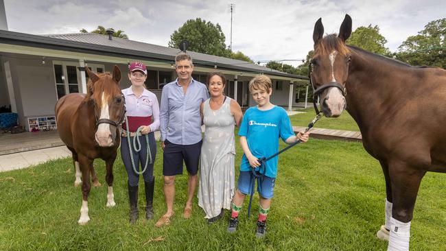 Kerri and Adam McKinnon and children in their backyard at Tallebudgera. Picture: Glenn Hunt