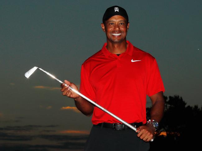 Tiger Woods of the United States poses with the trophy after winning the TOUR Championship