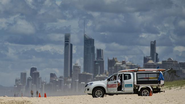 Gold Coast Lifeguards on duty at the Spit Beach, with Surfers Paradise skyline behind. Picture: Jerad Williams