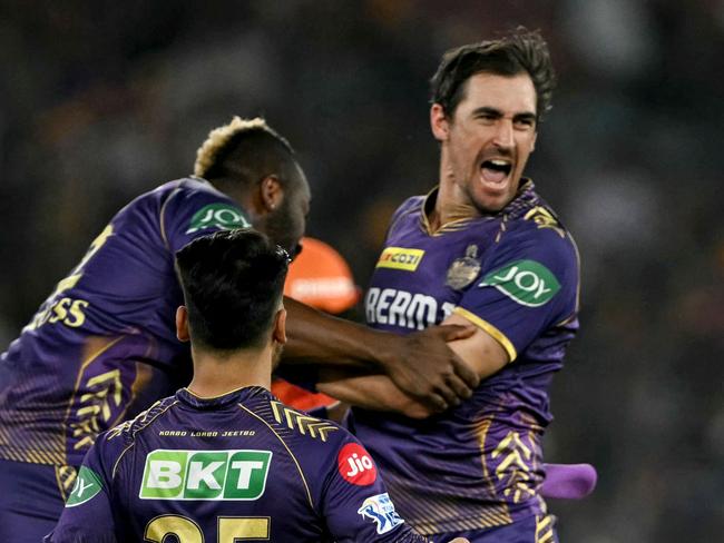 Kolkata Knight Riders' Mitchell Starc (R) celebrates with teammates after taking the wicket of Sunrisers Hyderabad's Travis Head (not pictured) during the Indian Premier League (IPL) Twenty20 first qualifier cricket match between Sunrisers Hyderabad and Kolkata Knight Riders at the Narendra Modi Stadium in Ahmedabad on May 21, 2024. (Photo by Punit PARANJPE / AFP) / -- IMAGE RESTRICTED TO EDITORIAL USE - STRICTLY NO COMMERCIAL USE --