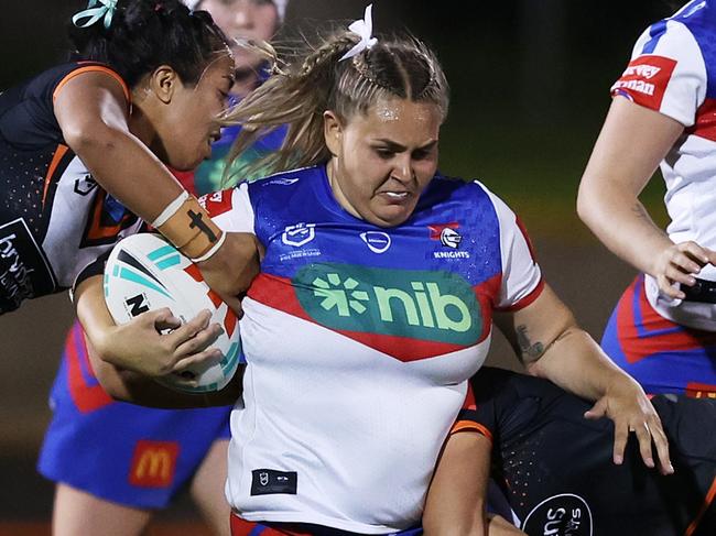 SYDNEY, AUSTRALIA - SEPTEMBER 14: Caitlan Johnston of the Knights is tackled during the round nine NRLW match between Wests Tigers and Newcastle Knights at Leichhardt Oval, on September 14, 2023, in Sydney, Australia. (Photo by Mark Metcalfe/Getty Images)