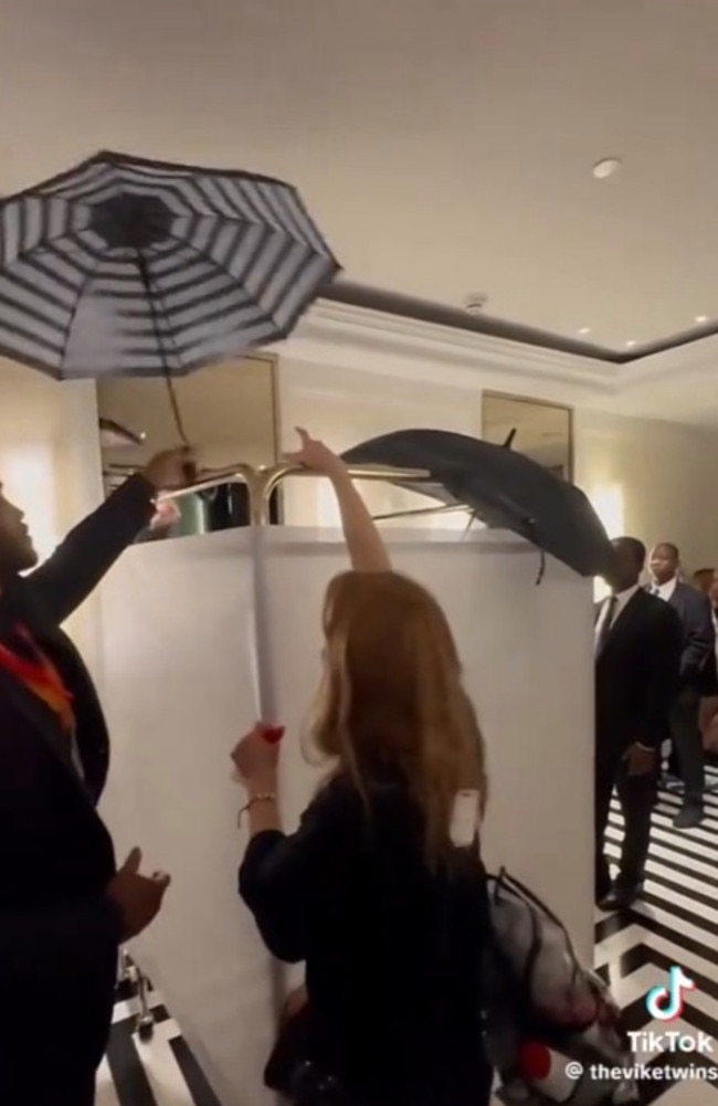 Doechii could be heard shouting at her team as they frantically tried to hide her outfit under umbrellas.