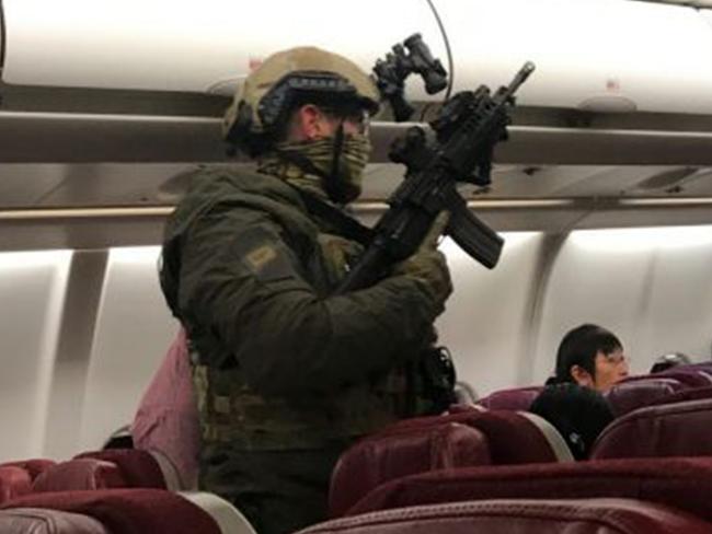 Police on-board the Malaysia Airlines jet. Picture: Andrew Leoncelli