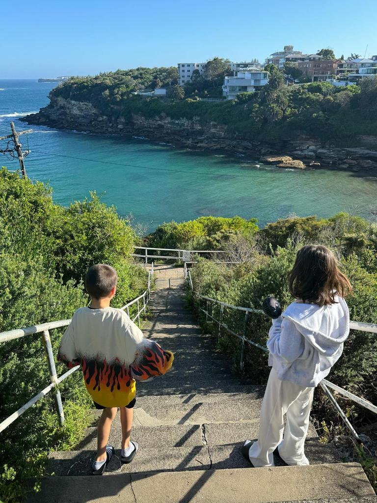 Kourtney’s two children Reign, eight, (left) and Penelope, 11, walking down stone stairs that lead to the beach. Picture: Instagram/KourtneyKardashian