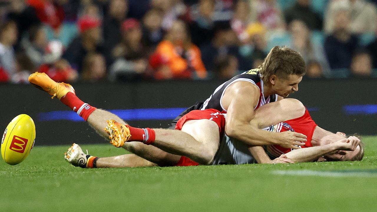 St Kilda's Dan Butler lays a heavy tackle on Sydney's Nick Blakey. Picture: Phil Hillyard