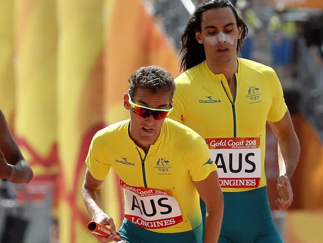 Men's 4x400m relay teams from left, Turks and Caicos Islands, India, Australia, Trinidad and Tobago and Jamaica exchange batons during their heat at Carrara Stadium during the 2018 Commonwealth Games on the Gold Coast, Australia, Friday, April 13, 2018. (AP Photo/Mark Schiefelbein)