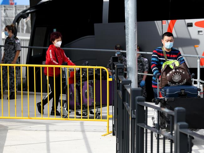 SYDNEY, AUSTRALIA - NewsWire Photos FEBRUARY, 28, 2021: Passengers arriving off international flights are seen  boarding charted buses to be taken to commence their 14 day COVID-19 hotel quarantine at Sydney International Airport, Sydney. NCA NewsWire/Bianca De Marchi