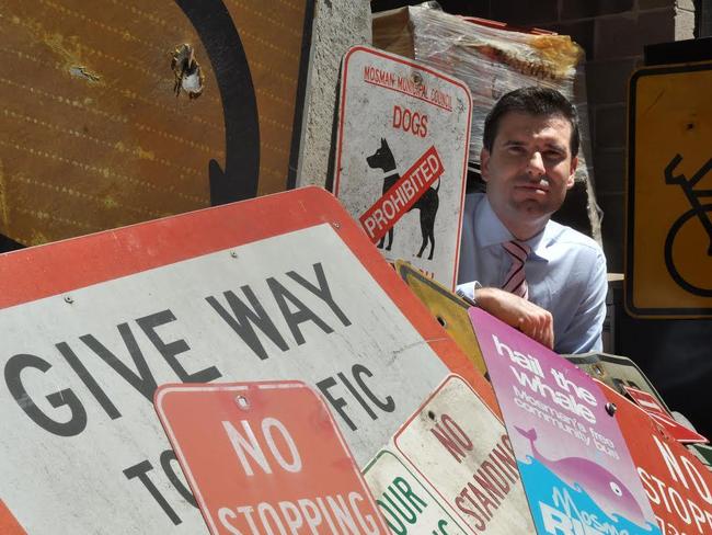 Mosman Council’s director of environment and planning Craig Covich with some of the scrapped signs.