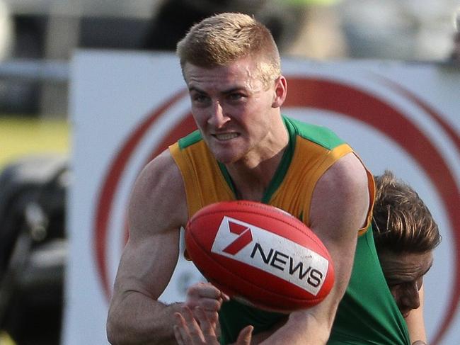 WRFL footy: Spotswood v Sunshine. Spotswood's Josh Drage releases a handball. Picture: LOCAL LEGENDS PHOTOGRAPHY