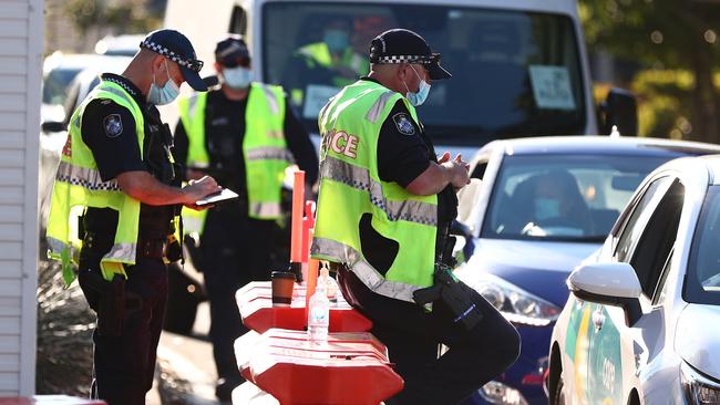 Police completing border checks at the Queensland-NSW border at Coolangatta. Picture: Chris Hyde/Getty Images