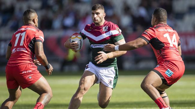 Alex Twal of Lebanon, centre, looks to evade the tackle of Manu Ma'u of Tonga.