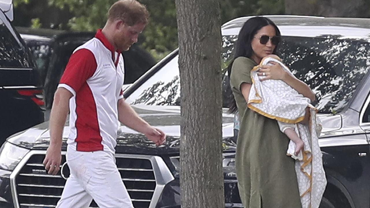 Prince Harry and Meghan, Duchess of Sussex walk with Archie at the Royal Charity Polo Day at Billingbear Polo Club.