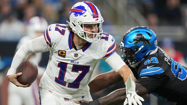 DETROIT, MICHIGAN - DECEMBER 15: Josh Allen #17 of the Buffalo Bills runs with the ball while being chased by Josh Paschal #93 of the Detroit Lions in the third quarter at Ford Field on December 15, 2024 in Detroit, Michigan. (Photo by Nic Antaya/Getty Images)