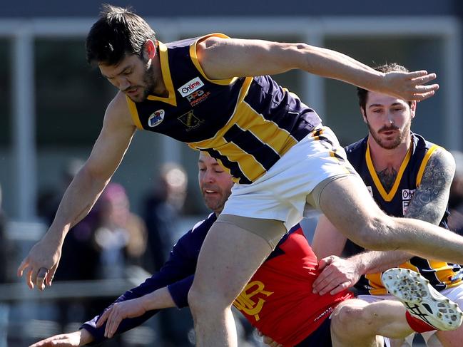 Cole Laurie of DRest is hit with a solid hip and shoulder by Brett Chambers of Ruperts during the RDFL football semi-final between Diggers Rest and Rupertswood played at Clarke Oval Sunbury on Saturday 31st August, 2019.