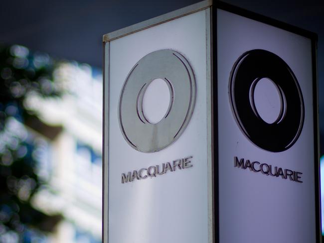 The Macquarie Group Ltd. logo is displayed on a signpost at the Macquarie Group Building in Sydney, Australia, on Friday, April 27, 2012. Macquarie Group Ltd., Australia's largest investment bank, said it's relying on cost cuts to revive earnings after a slump in trading income and dealmaking dragged full-year net income to an eight-year low. Photographer: Ian Waldie/Bloomberg