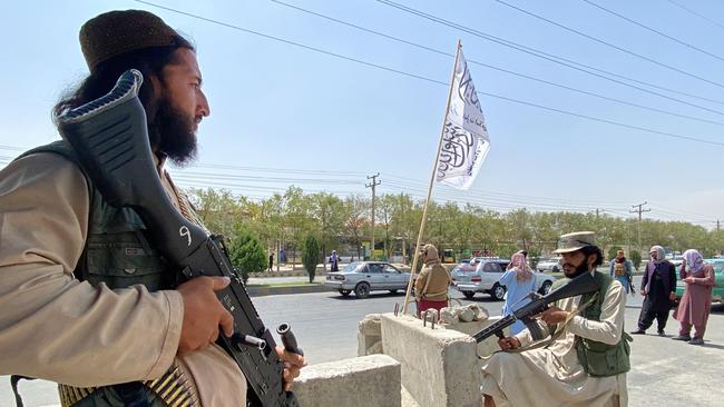 Taliban fighters stand guard at an entrance gate outside the Interior Ministry in Kabul. Picture: AFP