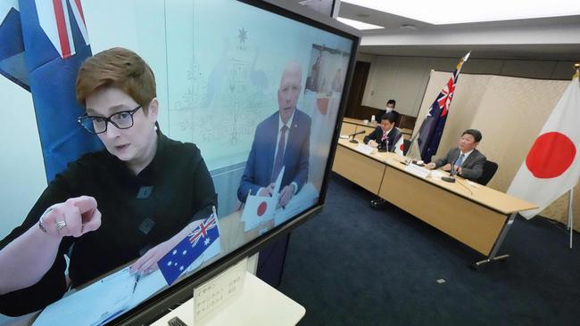 Japanese Foreign Minister Toshimitsu Motegi, right, and Defence Minister Nobuo Kishi in Tokyo during a video conference with Foreign Minister Marise Payne, left on screen, and Defence Minister Peter Dutton on Wednesday. Picture: AFP