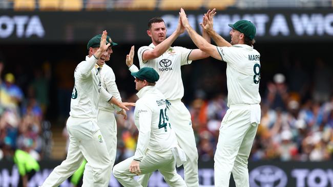 Josh Hazlewood is mobbed by his teammates after dismissing Virat Kohli Picture: Getty Images