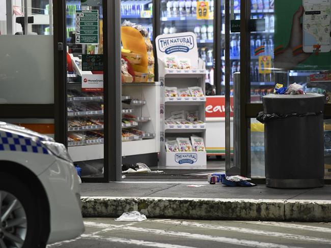 A police car outside the 7-Eleven in the minutes following the axe rampage which put Sharon Hacker and Ben Rimmer in hospital with head injuries. Picture: Gordon McComiskie