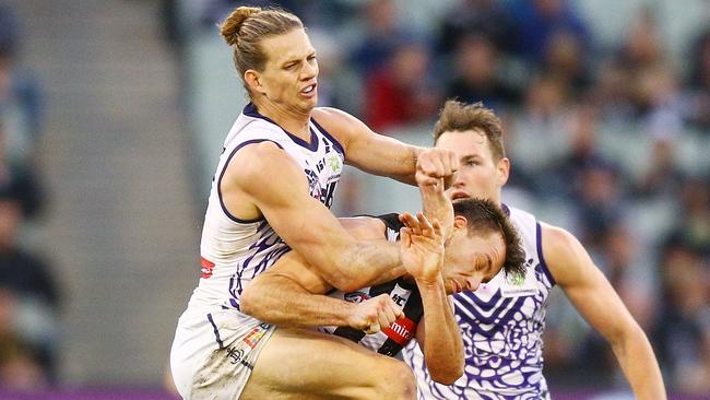 Nat Fyfe makes high contact with Collingwood’s Levi Greenwood on Sunday. Picture: Getty Images