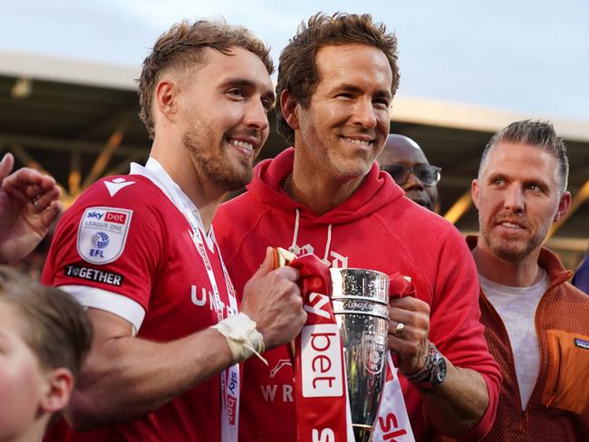 Wrexham AFC attacker Sam Smith and co-owner Ryan Reynolds celebrate the club’s promotion to the English Championship. Picture: Kya Banasko/Getty Images