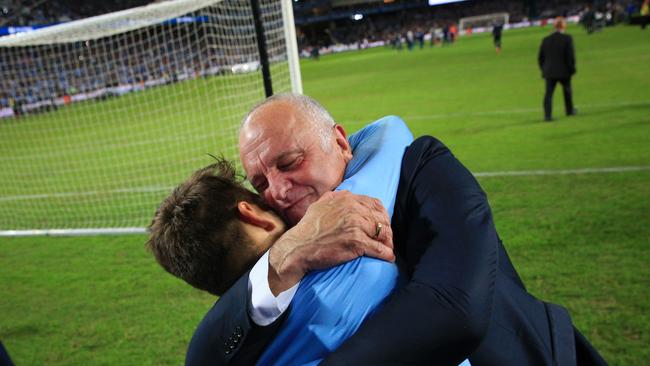 Graham Arnold celebrates with Milos Ninkovic after winning the penalty shoot-out. Picture: Mark Evans