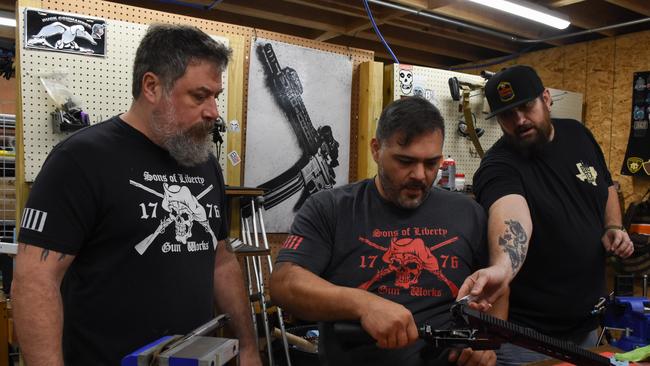 Sons of Liberty Gun Works owner Mike Mihalski inspects an M89 AR15 in his San Antonio warehouse.