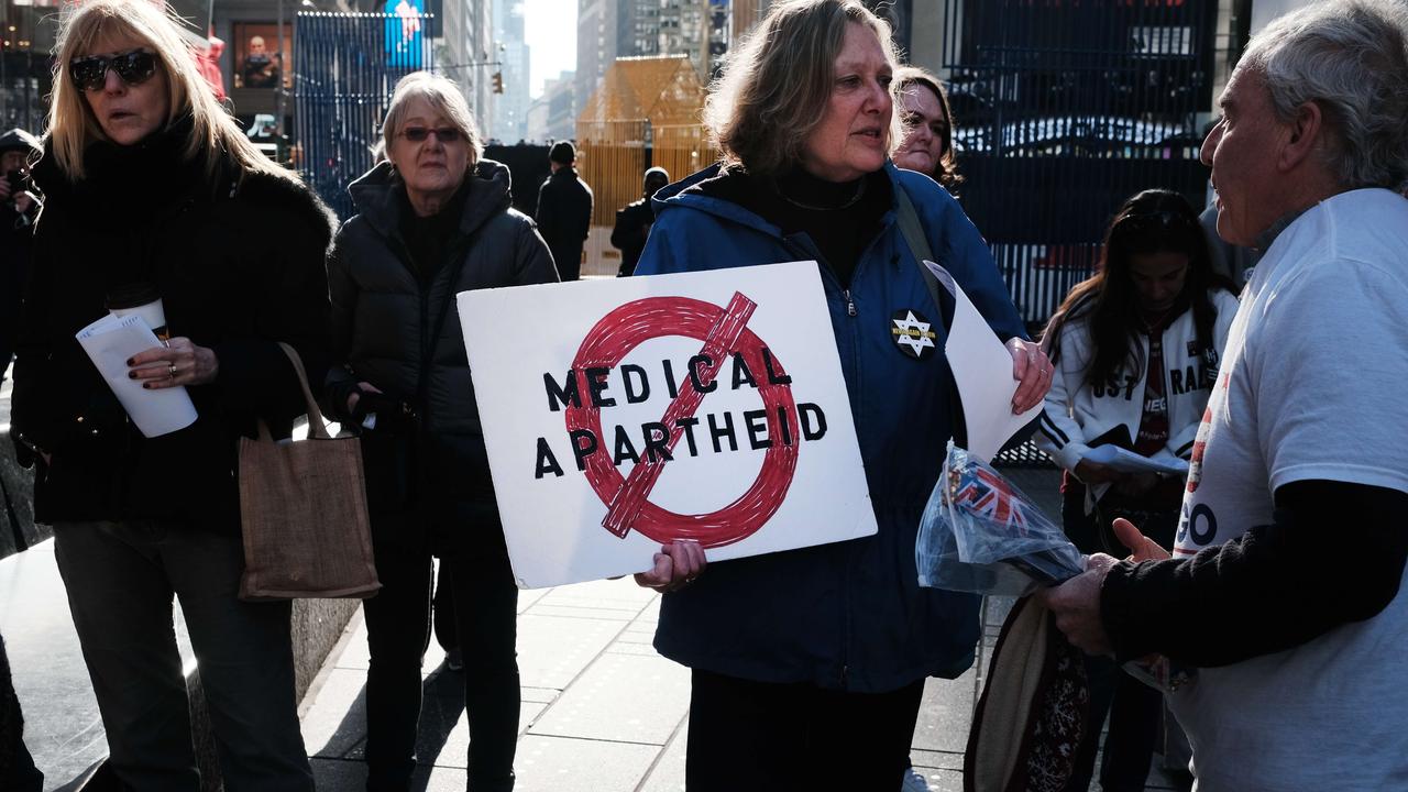 A group of protesters gather in Times Square in Manhattan to show their opposition to Covid-19 vaccines.