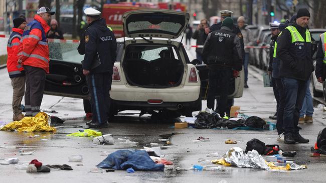 Clothing and items are strewn across the street where police and emergency services investigate the car ramming. Picture: Johannes Simon / Getty