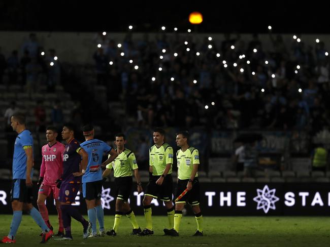 SYDNEY, AUSTRALIA - APRIL 07: Players and officials walk from the ground after the stadium lights went out during the A-League match between Sydney FC and Perth Glory at Netstrata Jubilee Stadium, on April 07, 2021, in Sydney, Australia. (Photo by Ryan Pierse/Getty Images)